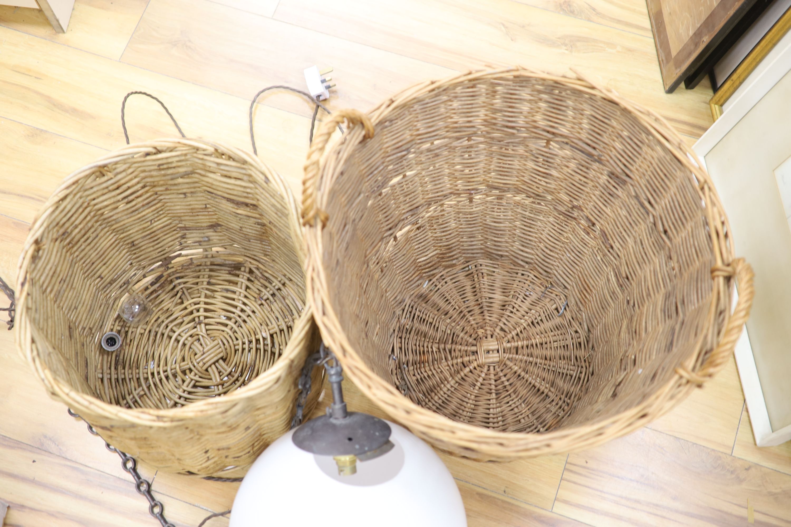 A glass hanging lamp and two wicker baskets